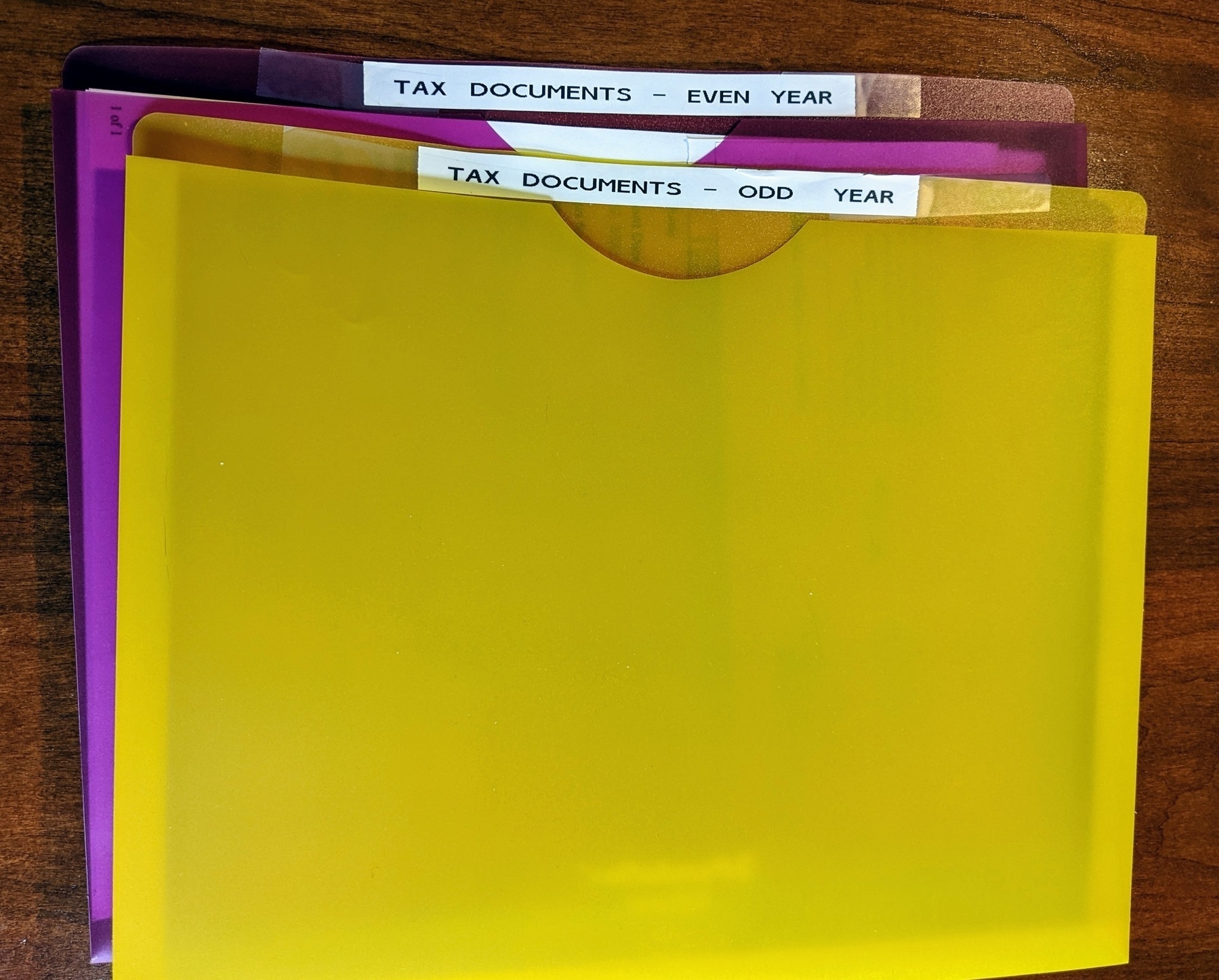 two file jacket folders labeled tax documents - even year and tax documents - odd year