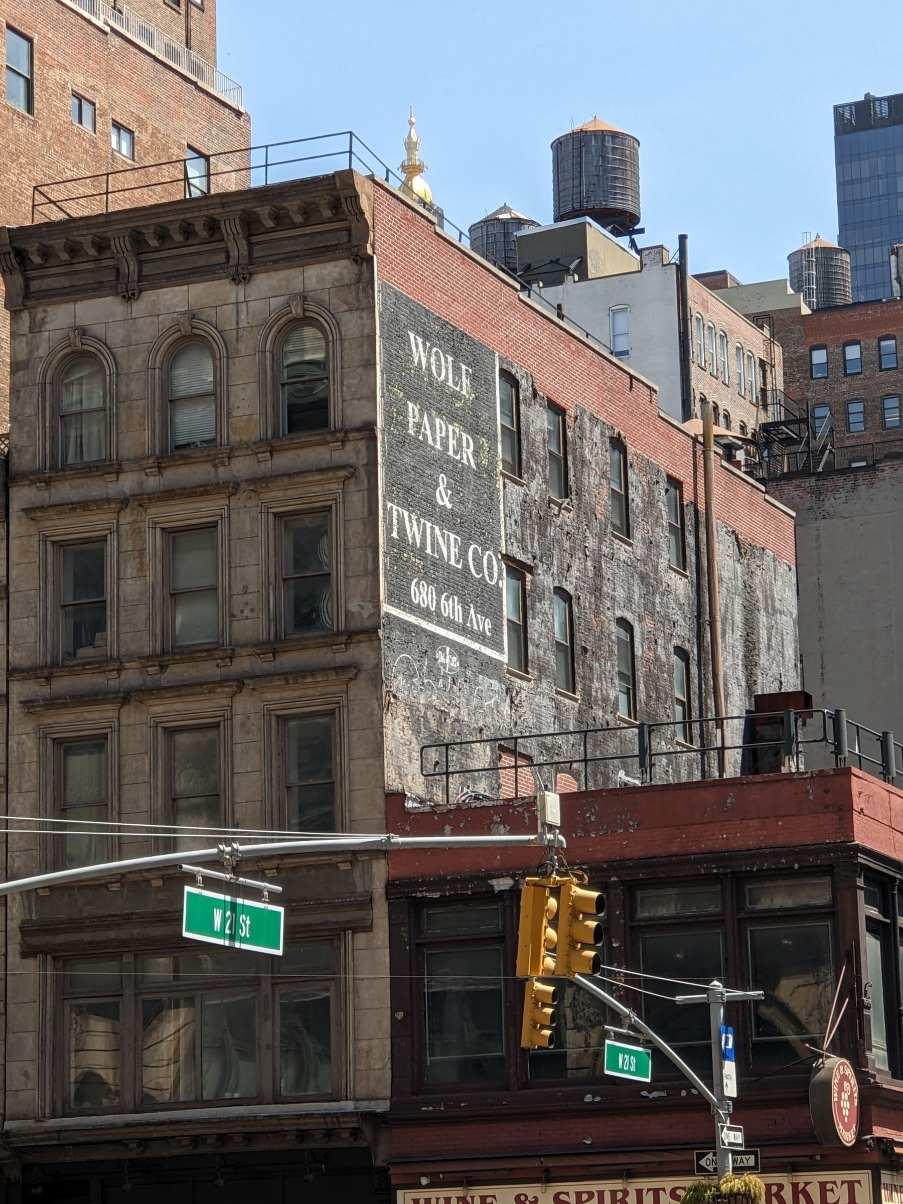 sign For Wolf's Paper and Twine Company painted on the side of a brick building